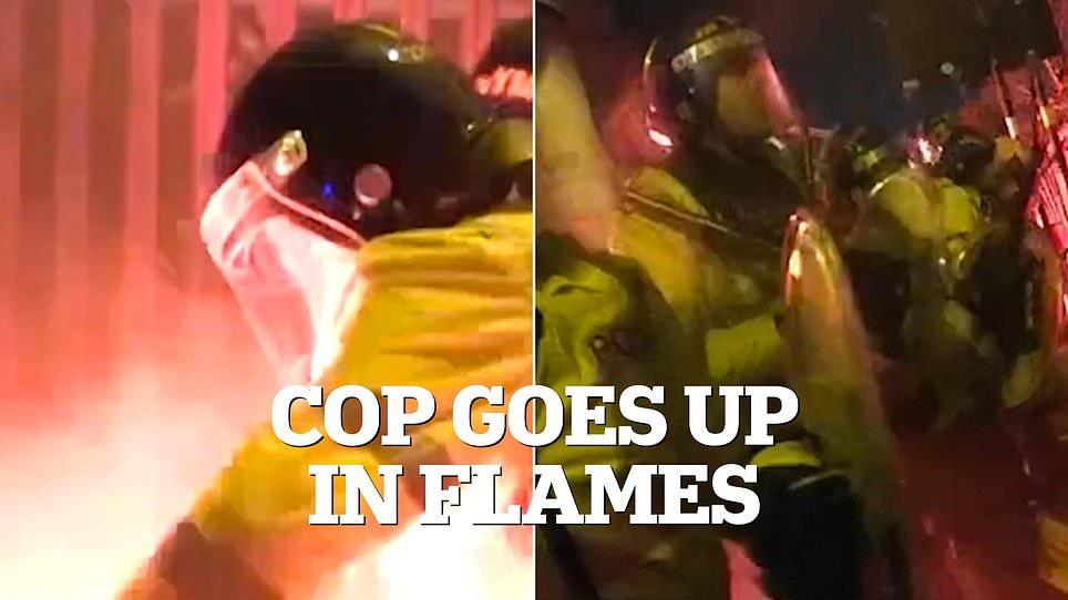 Terrifying moment police officer goes up in flames as Polish hooligans launch 'worst football violence seen in decades' on British streets